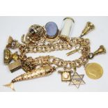 A gold charm bracelet featuring nine 9ct gold charms approx. wt. 16g, an Edward VII 1910 half
