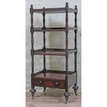 A four tier mahogany whatnot with lower drawer, turned supports and brass castors, 19th century,