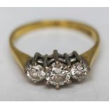 A hallmarked 18ct gold three stone diamond ring, gross wt. 2.21g, size K.