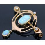 An Edwardian Art Nouveau opal and seed pearl brooch, the central precious oval opal cabochon in