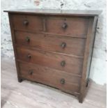A utilitarian style oak chest of drawers circa 1920s with turned handles, width 107cm, depth