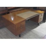 A Gordon Russell pedestal desk with partial leather top, stamped and dated 1963 underneath, width
