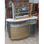 A 1960s retro bar of shaped form with brass and black moulding, marble effect top, above curved