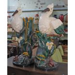 A pair of large reproduction majolica stick stands in the form of storks amongst foliage with frog