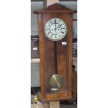 A walnut cased 8 day wall clock, with pendulum, key and weights, total length approx 87cm.