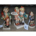 A group of three Hummel figures - Merry Wanderer, Little Hiker, and Little Mothers (Going to