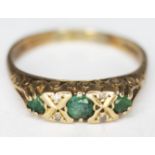 A hallmarked 9ct gold emerald and diamond ring, gross wt. 2.51g, size Q.