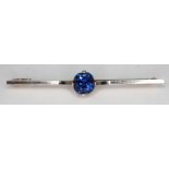 A sapphire brooch featuring a cushion cut natural blue sapphire weighing approx. 2.65 carats,