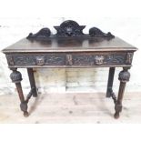 A Victorian Dutch style carved oak two drawer side table, width 107cm, depth 43cm & height 95cm.