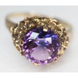 A 9ct gold ring set with a round brilliant cut amethyst, the stone approx. 4.44 carats, band