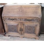 A late Victorian carved oak bureau, width 115cm, depth 52cm & height 108cm.
