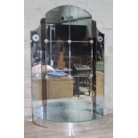 An Art Deco panelled glass mirror with lower demi-line shelf, chrome rosettes and etched glass