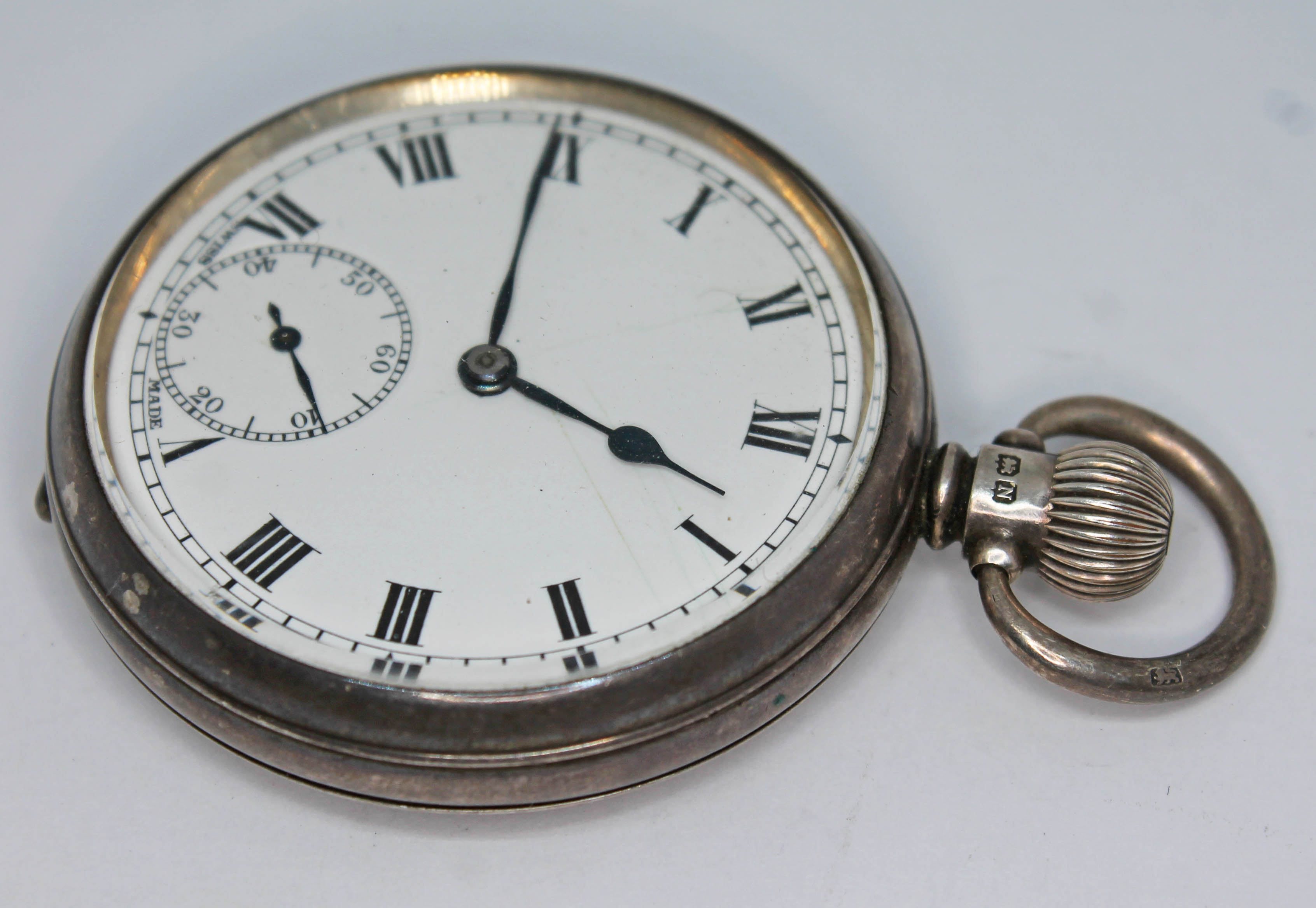 A 1930s hallmarked silver Helvetia pocket watch with white dial, Roman numerals and hands in black