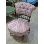 A Victorian ebonised and upholstered chair.