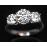 A three stone diamond ring, the central modern round brilliant cut diamond approx. 1.93 carats,