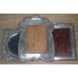 A group of three early 20th century hallmarked silver photo frames, heights 18cm - 21cm.