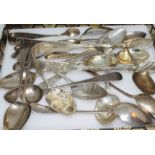 A mixed lot of hallmarked silver comprising two pairs of sugar tongs and various teaspoons,