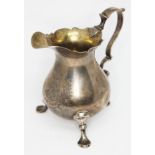 A George II silver cream jug, pear shaped with gilt interior, cast pad feet, scratch weight 2=18