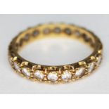 A hallmarked 18ct gold eternity ring set with with colourless stones, gross wt. 3.41g, size P.