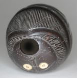 A carved coconut bugbear powder flask with bone eyes, length 10cm.