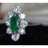 An Art Deco diamond emerald ring featuring a marquise cut central emerald weigh approx. 0.82