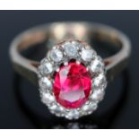 A hallmarked 9ct gold ruby and colourless stone cluster ring, gross wt. 2.31g, size M.