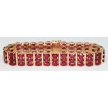 A diamond and ruby bracelet featuring 81 oval mixed cut rubies, total wt. approx. 28.266 carats,