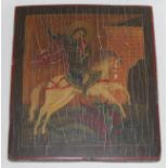 A Russian orthodox icon, polychrome decoration depicting St George & the Dragon, on wooden panel,