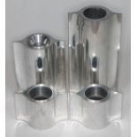 Georg Jensen, a group of four aluminium tea light candle holders, heights 6cm - 18cm.