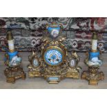 A French gilt metal clock garniture with Sevres porcelain dial and panels.