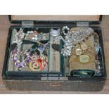 A leather bound jewellery casket and contents.