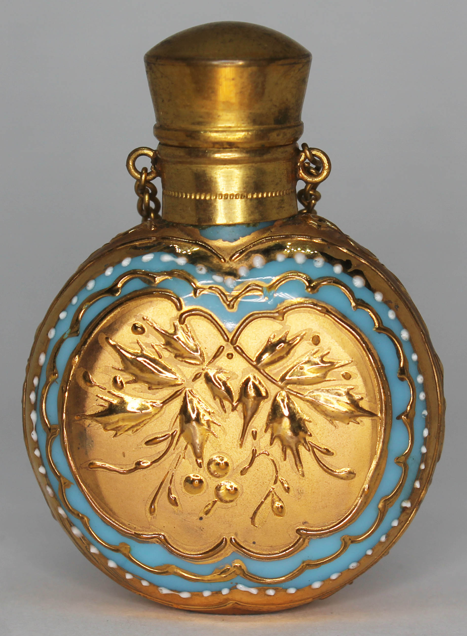 A continental gilt and enamelled glass scent bottle, length 55mm. Condition - part of glass
