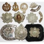 Royal Scots and other regimental badges, together with a belt buckle.