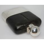 A silver plated and leather covered glass hip flask, length 16cm. Condition - good, glass damage