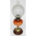 A Duplex oil lamp with pressed glass reservoir, embossed brass pedestal and stoneware foot, with