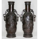 A pair of archaic bronze vases, each with applied decoration depicting mythical birds, dragons and