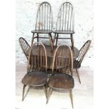 An Ercol dark elm and beech drop leaf table and six spindle back chairs.