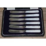 A cased set of six hallmarked silver and mother of pearl handle butter knives.