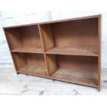 An open oak bookcase with visible dovetail/mortise and tenon joints and two adjustable shelves,
