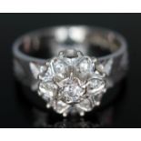 A white gold diamond cluster ring, the flower cluster diam. approx. 10mm, marked '18ct, gross wt.