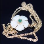 A 9ct gold mounted mother of pearl and emerald flower head pendant on chain marked '375', pendant
