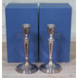 A pair of Elizabeth II hallmarked silver candlesticks, filled, Carrs, Sheffield, height 25cm, with