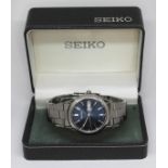 A stainless steel Seiko Analog day date automatic.