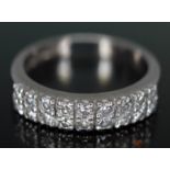 A hallmarked 18ct gold diamond half eternity ring featuring 18 pave set modern round brilliant cut