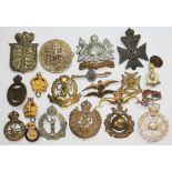 A quantity of military cap badges.