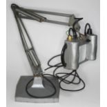 A Herbert Terry & Sons industrial grey anglepoise magnification lamp on weighted square base.