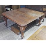 A Victorian oak wind out table with scroll cabriole legs and four leaves, stamped 'Fryer & Son', the