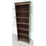 A narrow open oak bookcase circa 1930 with adjustable shelving, width 61.5cm, depth 21.5cm &
