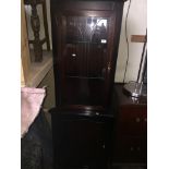 A glazed corner cabinet