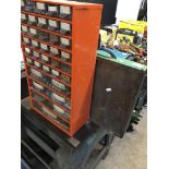 A metal multidrawer cabinet and wooden box of assorted rivets, screws, fuses, etc.